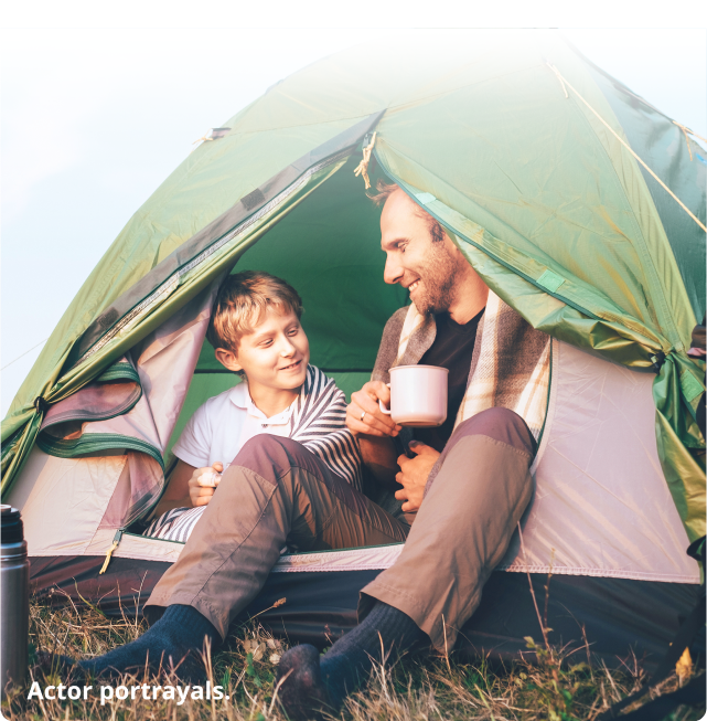 Father and son sitting in a tent