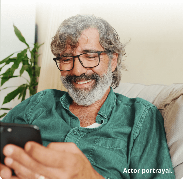 Man smiling at his phone